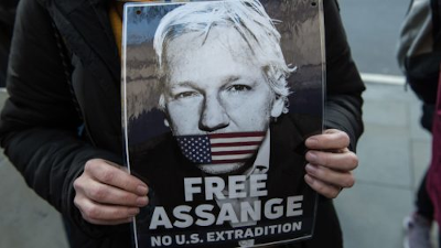 Free Assange. No US Extradition. Cartel sostenido con las manos. Free Assange. No US Extradition. Cartel sostenido con las manos.