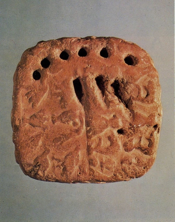Tablet with impressed signs that may represent the number 63.